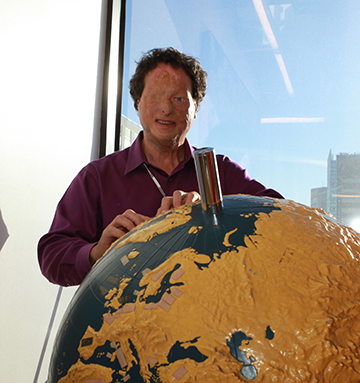 Josh Miele examines a tactile globe.